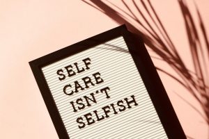 Cuadro con frase “Selfcare isn’t selfish” que promueve el autocuidado y el bienestar emocional en desarrollo personal.